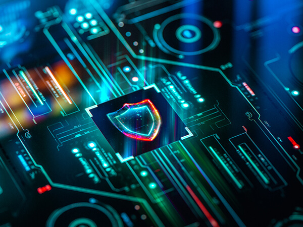 Business D Dos mitigation Features 600x450 Shield-looking image centered above a lighted circuit board
