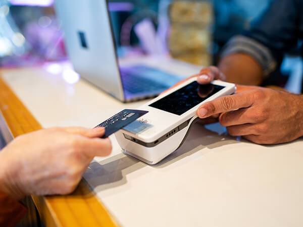 Person scanning credit card with a POS card reader