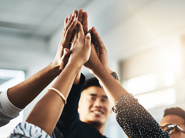 Careers Core Values Features 600x450 Group of people raising hand and high-fiving
