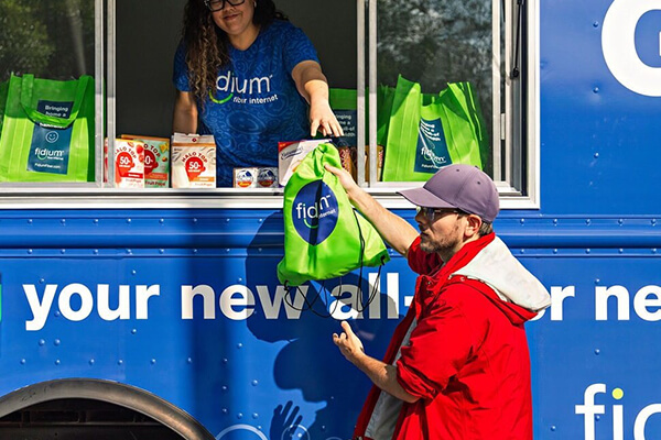 About Us Fidium Blue Truck Sub Hero 600x400 Fidium food truck handing out goodies