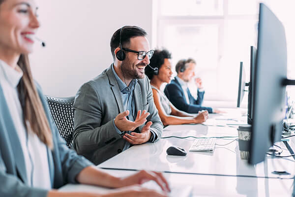 Group of call center workers talking on headsets