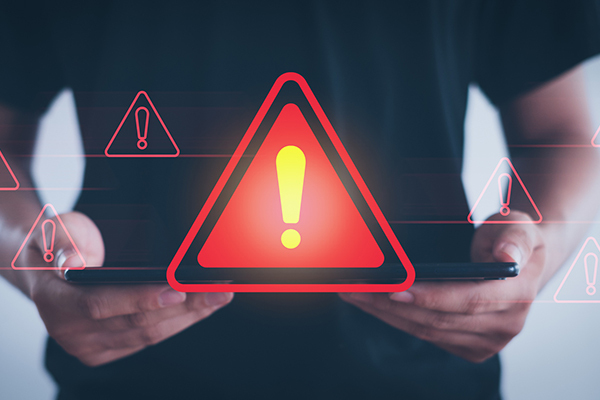 Abstract of a red caution sign coming from a tablet