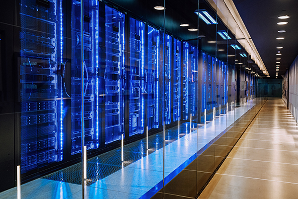 View of a large data center with racks all lit up in blue