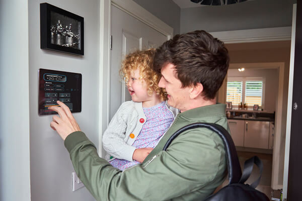Man holding daughter looking at a picture