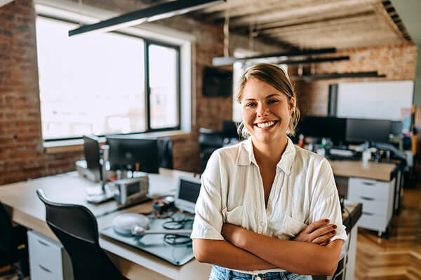 Woman posing for camera in front of her desk