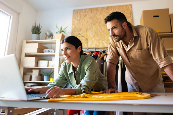 Woman and man looking at computer screen in retail shop