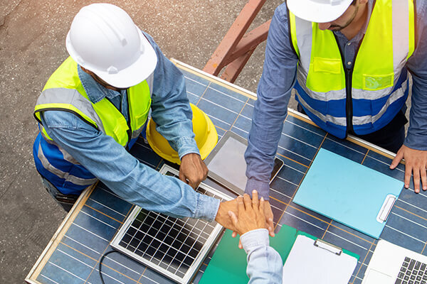 Construction team putting hands together in commradre