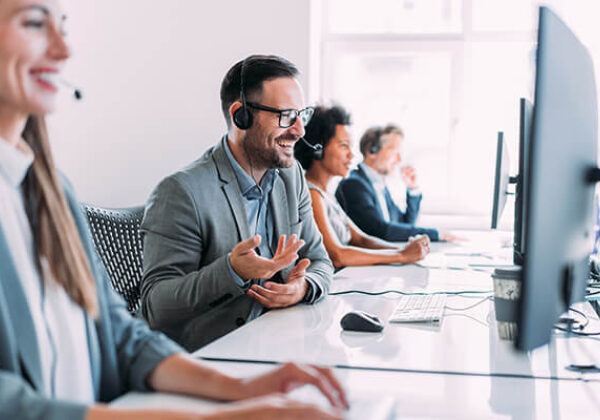 Group of call center workers talking on headsets
