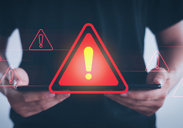 Abstract of a red caution sign coming from a tablet