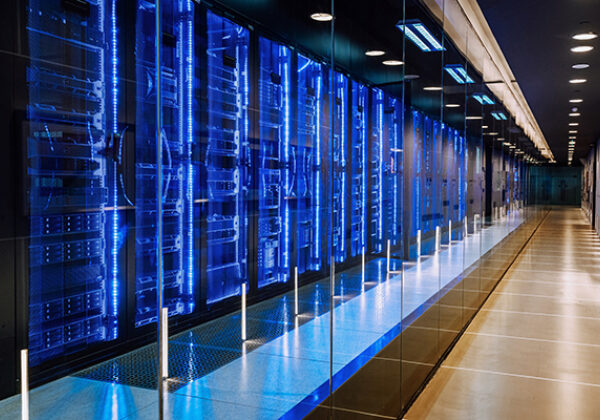 View of a large data center with racks all lit up in blue