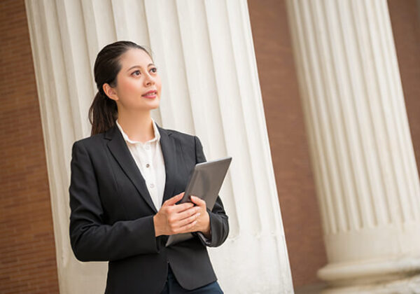 Business Federal Government Solutions Sub Hero 600x400 Woman standing outside of government building