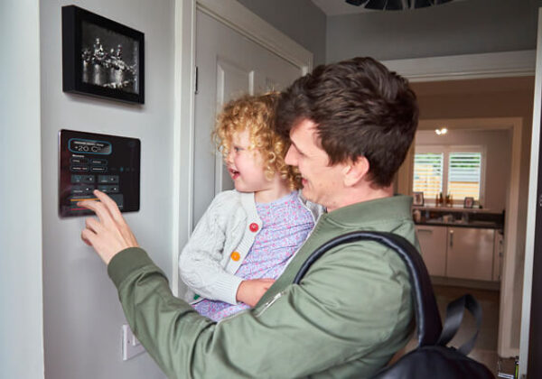 Man holding daughter looking at a picture