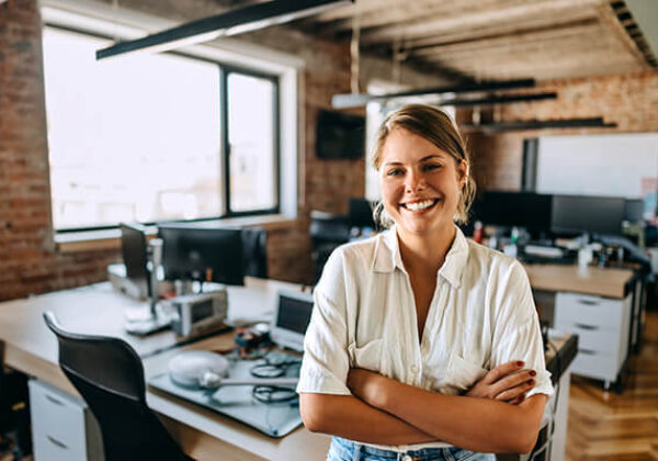 Woman posing for camera in front of her desk