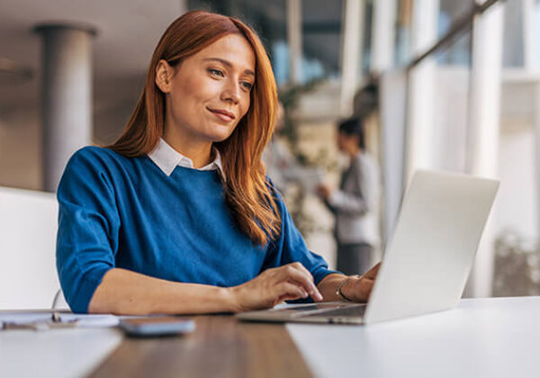 Wholesale Systems E Bonding Sub Hero 600x400 Woman sitting and typing on laptop