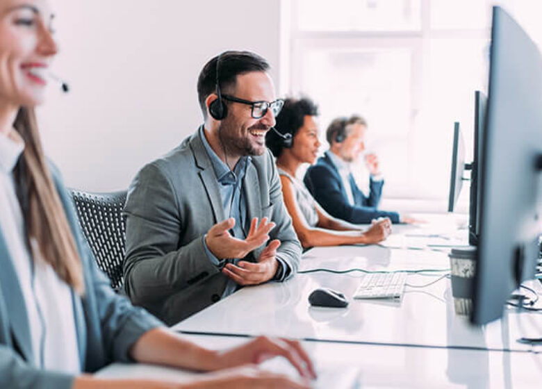 Group of call center workers talking on headsets