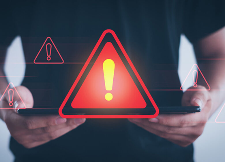 Abstract of a red caution sign coming from a tablet