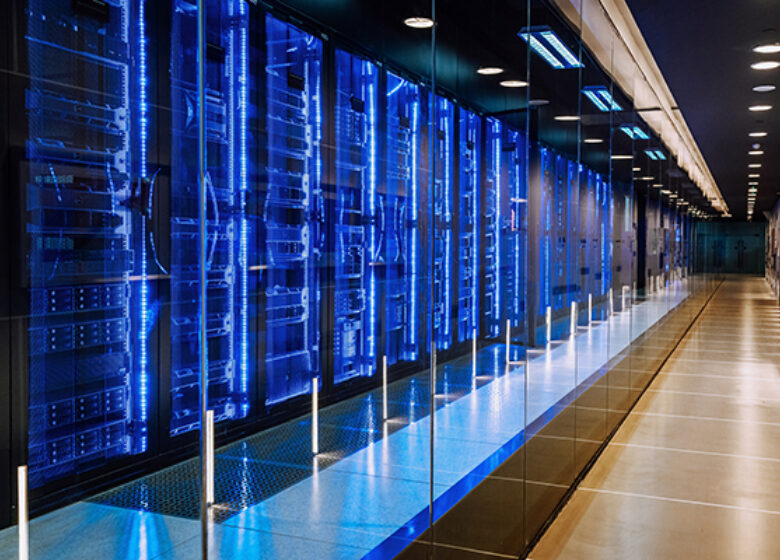 View of a large data center with racks all lit up in blue