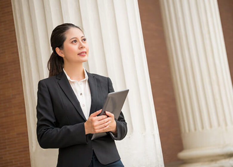 Business Federal Government Solutions Sub Hero 600x400 Woman standing outside of government building