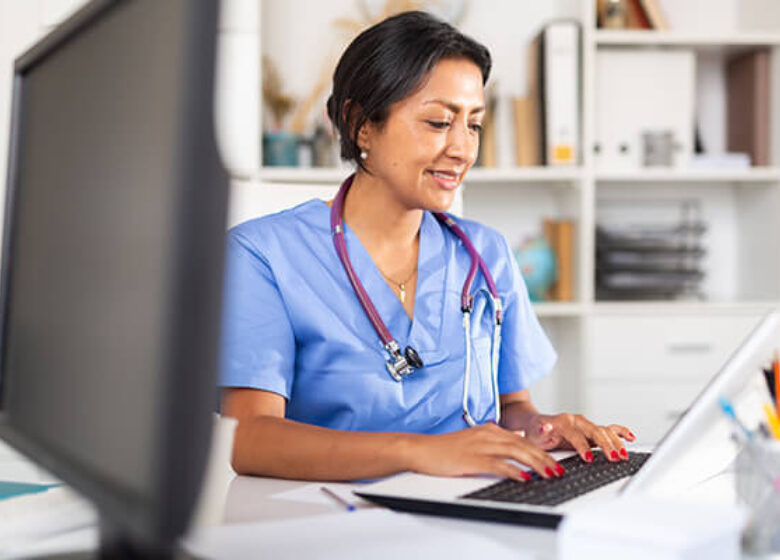Medical worker typing on a laptop