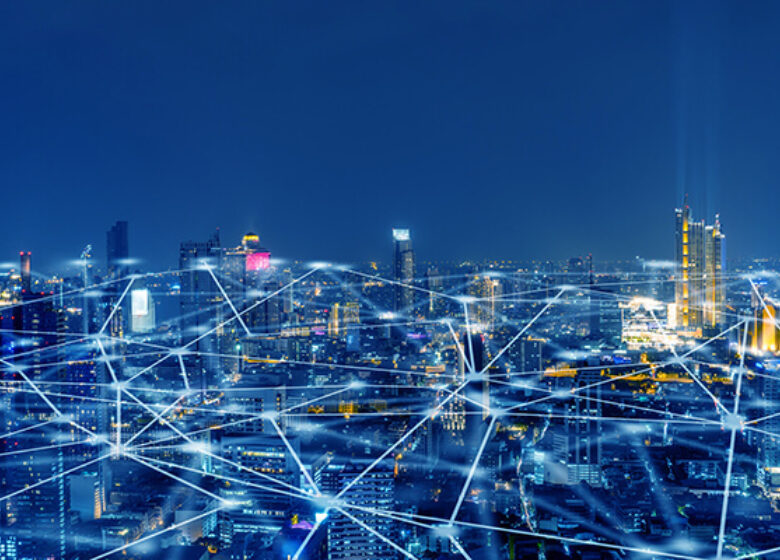 City sky view with grid of lights and dots across the city