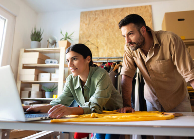 Woman and man looking at computer screen in retail shop