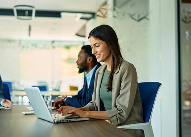 Wholesale Cust Doc Wholesale Broadband Sub Hero 600x400 Woman working on laptop in a conference room