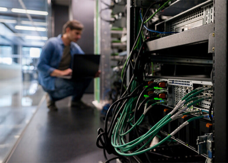 Wholesale Data Center Providers Hero 600x400 Data center technician looking at equipment