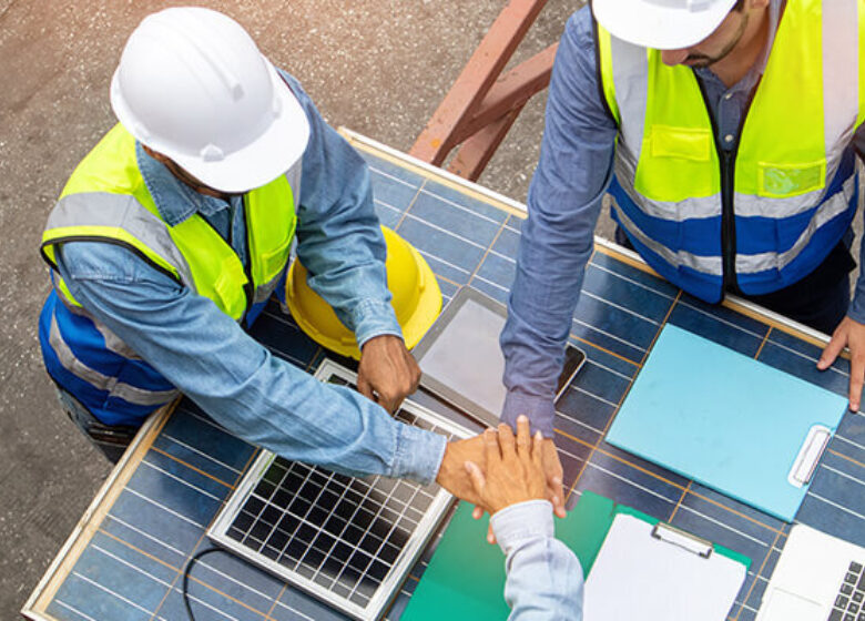 Construction team putting hands together in commradre