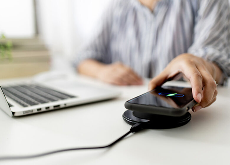 Wholesale Network Changes Notices Sub Hero 600x400 Person charging phone at desk